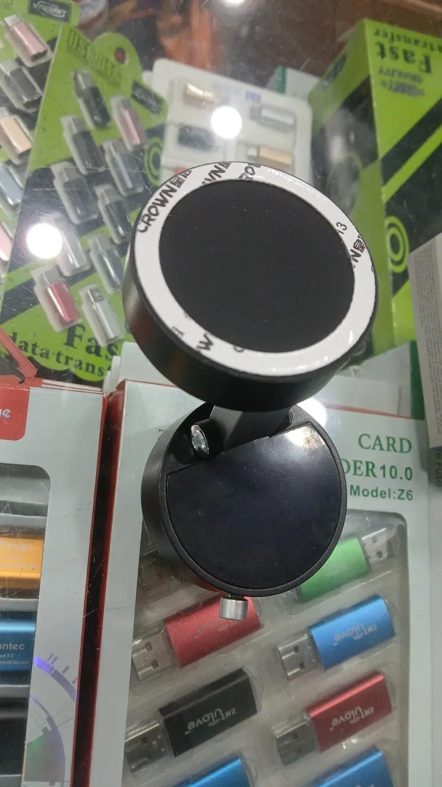 Black circular car phone holder mount displayed among electronic accessories