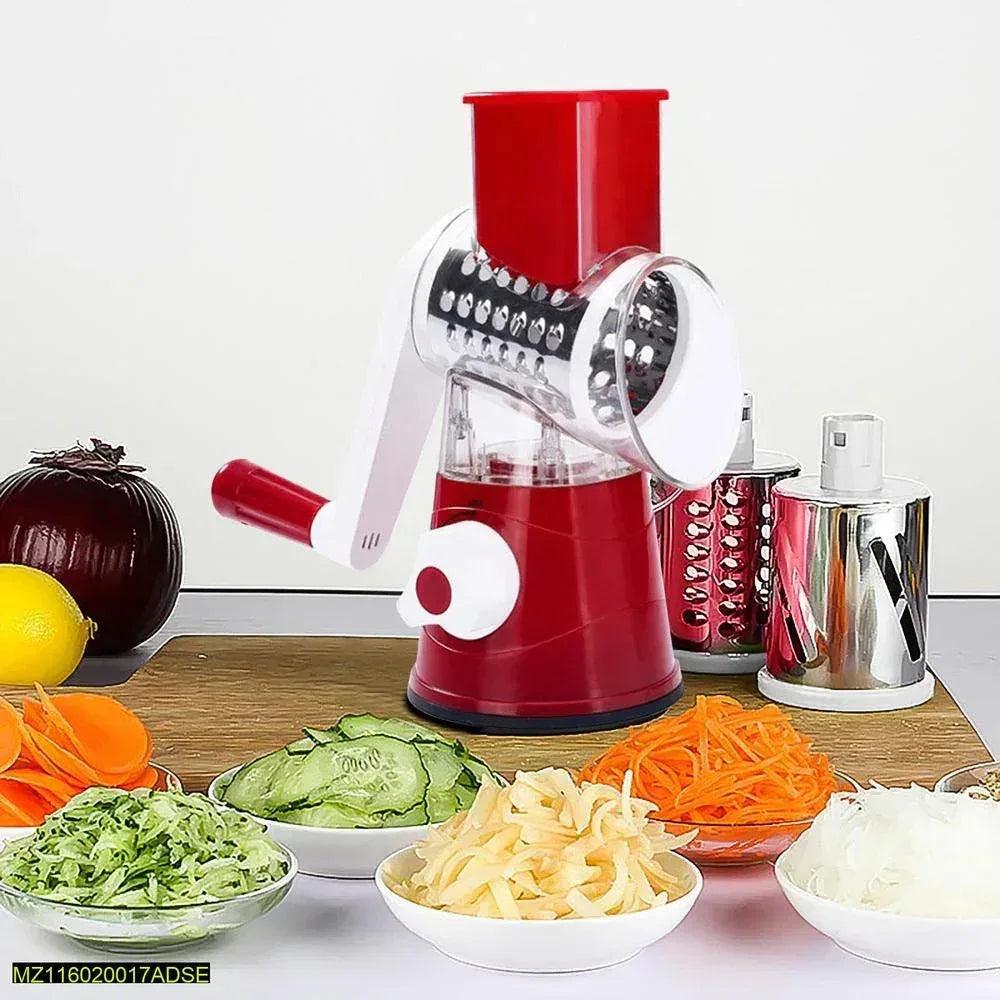 Multifunctional red rotary vegetable slicer and grater with sliced carrots, cucumbers and onions